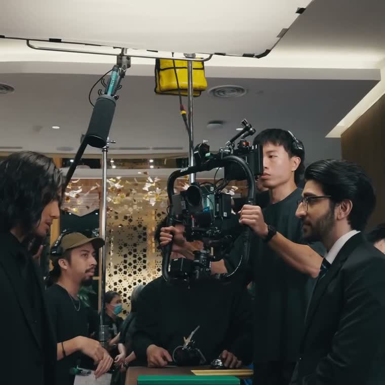 The unit working around the camera rig with talent on set