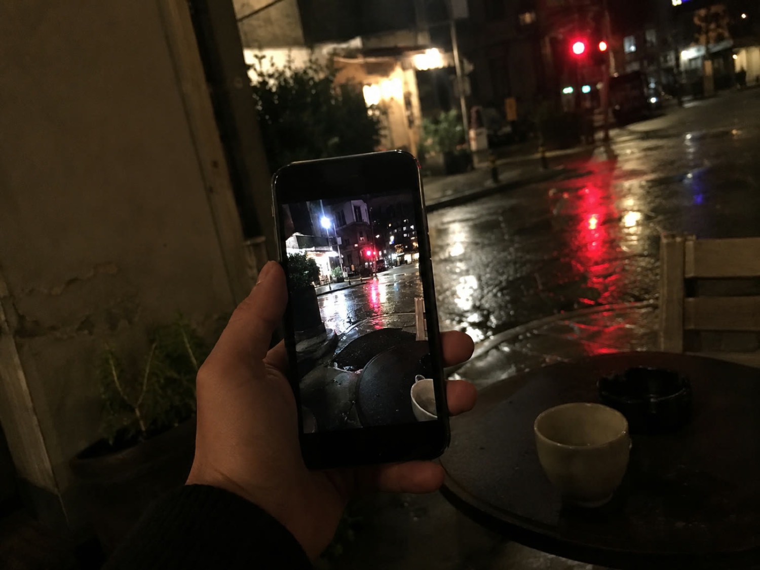 Shooting a rain-soaked street at night on a phone